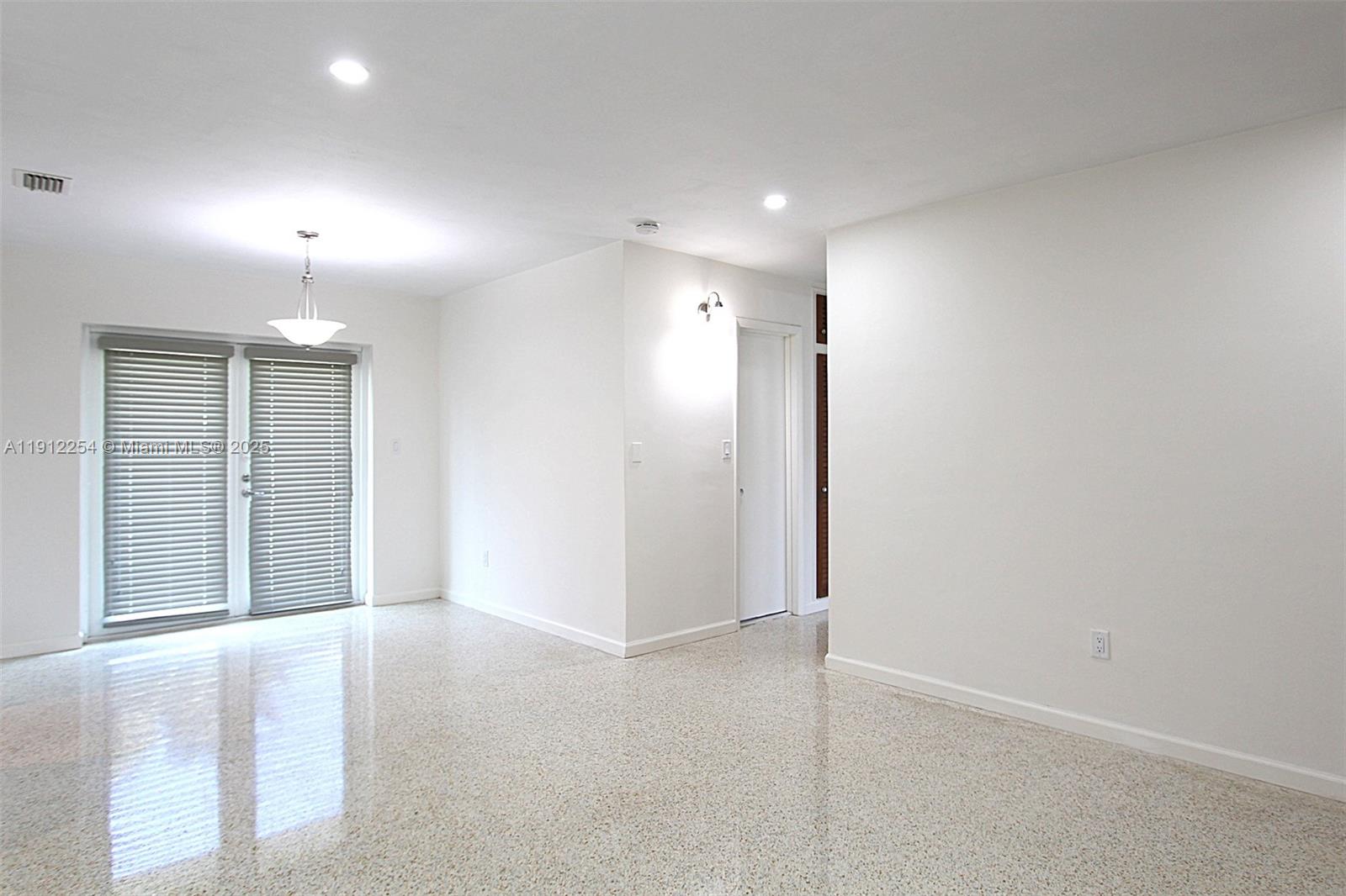 6203 Southwest 108th Place Miami, FL 33173 - Photo 5 of 23 an empty room with windows and cabinet