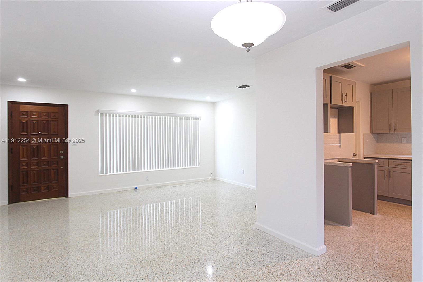6203 Southwest 108th Place Miami, FL 33173 - Photo 7 of 23 a view of an empty room with a kitchen