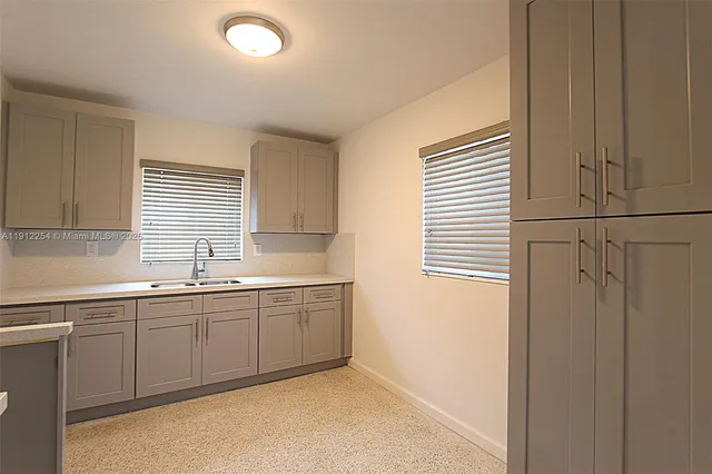 a kitchen with sink and window