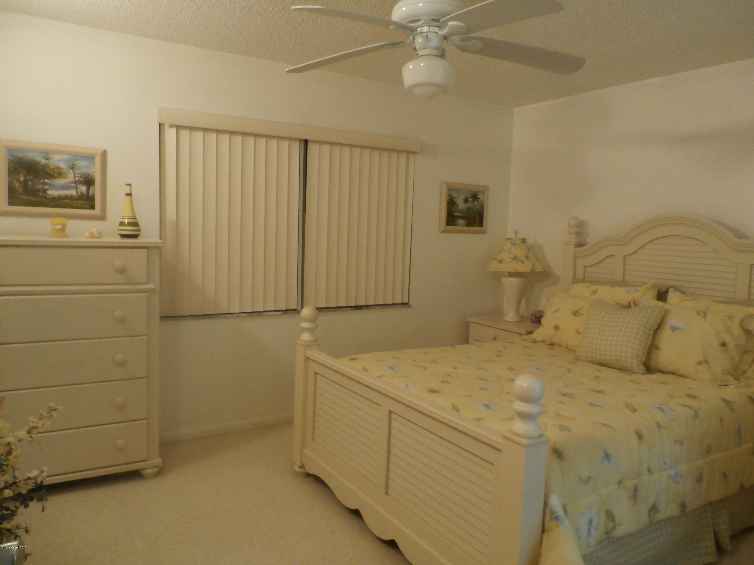 538 Trend Road West Melbourne, FL 32904 - Photo 11 of 16 a bedroom with a bed and a cabinets
