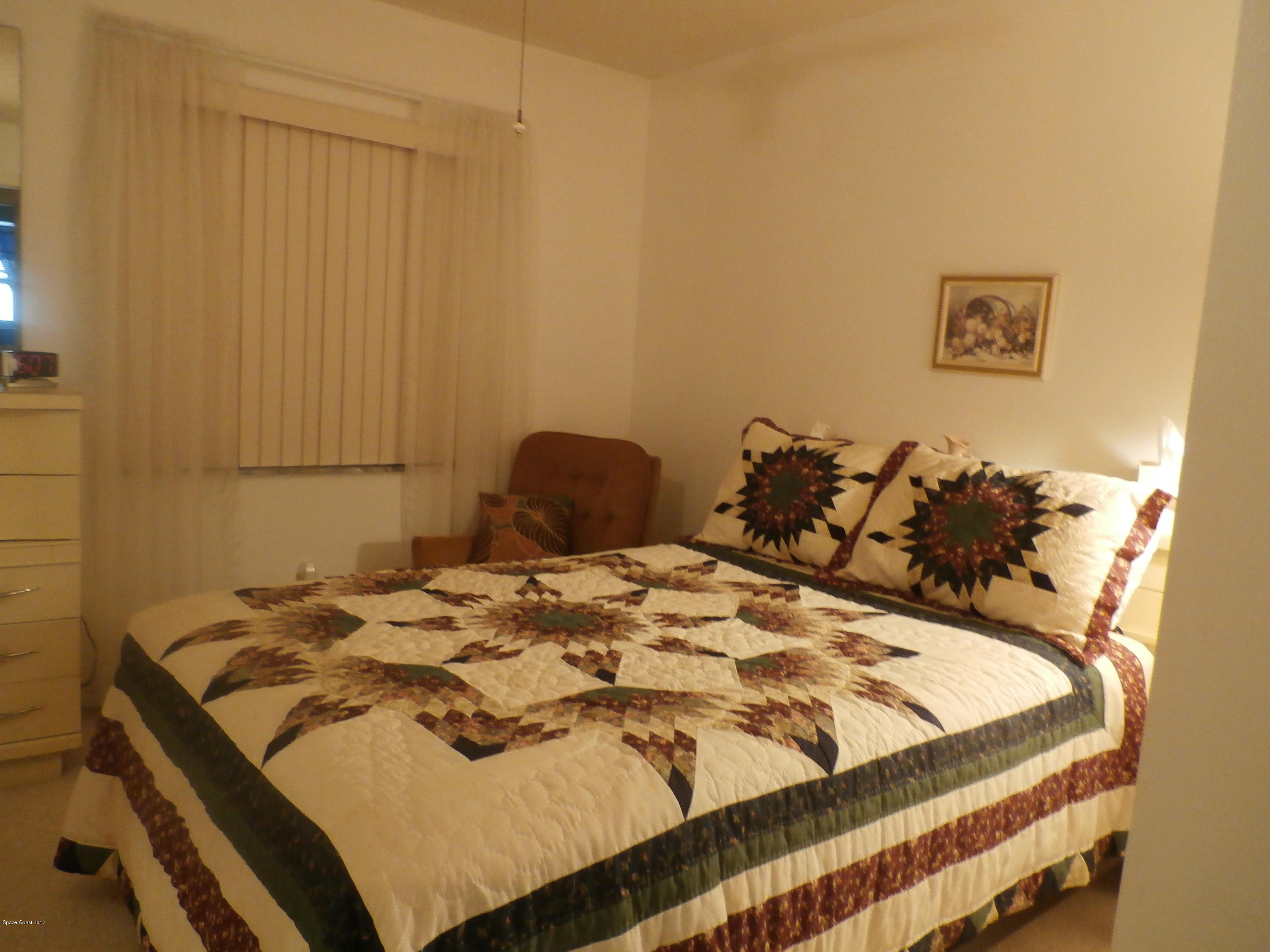 538 Trend Road West Melbourne, FL 32904 - Photo 13 of 16 a bed sitting in a bedroom next to a cabinet