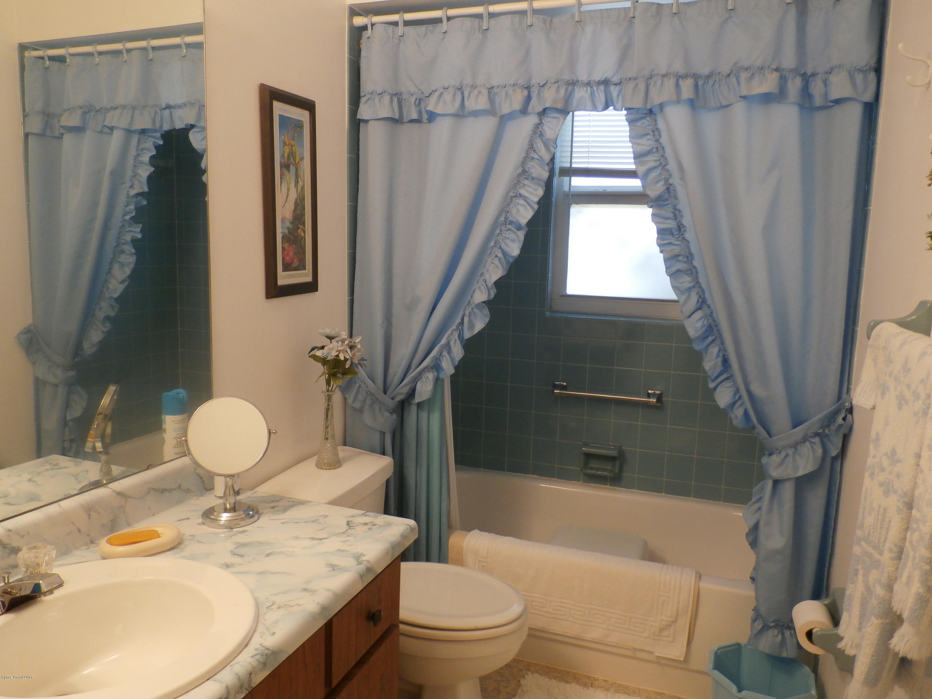 538 Trend Road West Melbourne, FL 32904 - Photo 14 of 16 a bathroom with a granite countertop sink toilet and shower