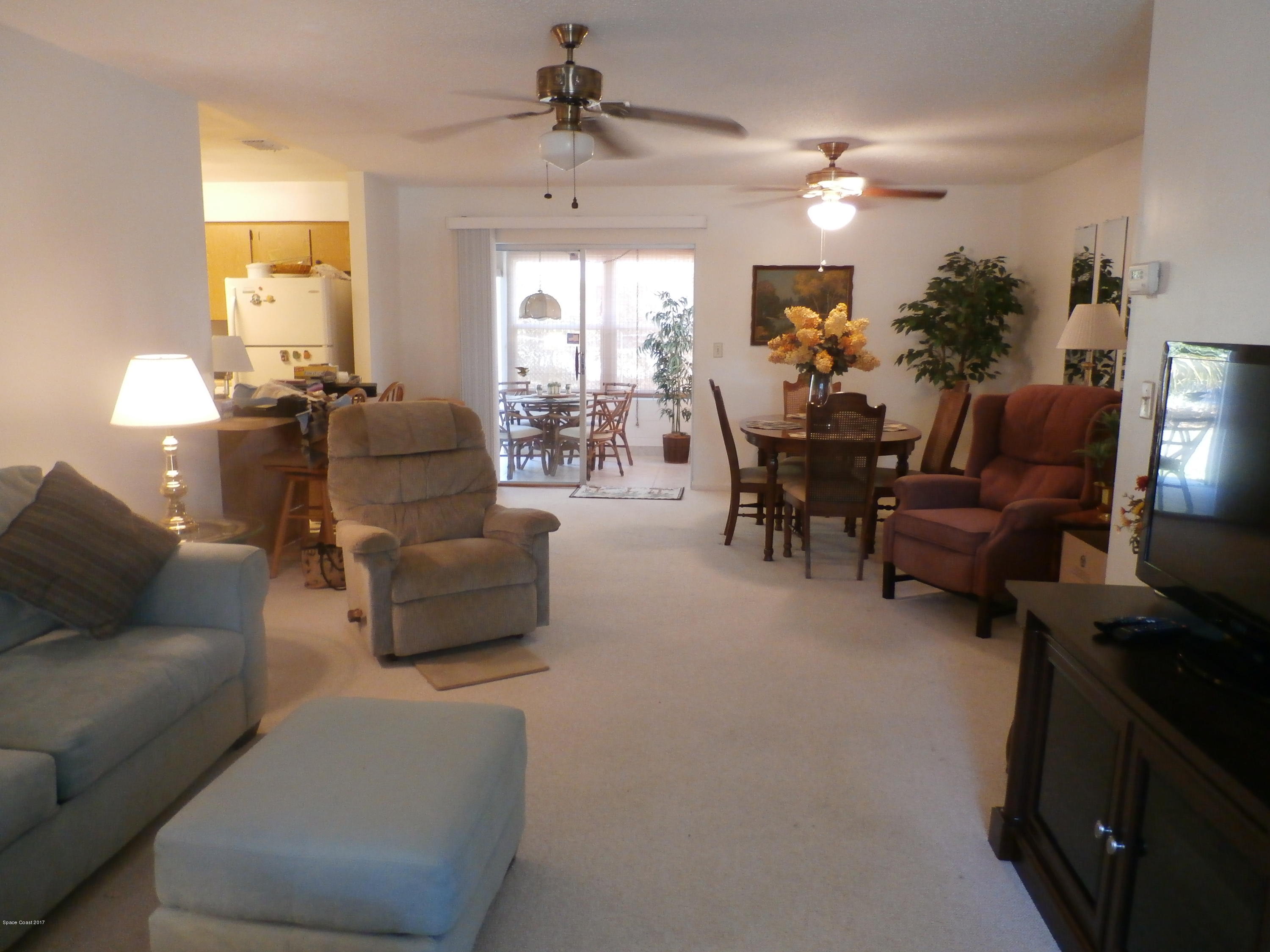 538 Trend Road West Melbourne, FL 32904 - Photo 3 of 16 a living room with furniture and a chandelier