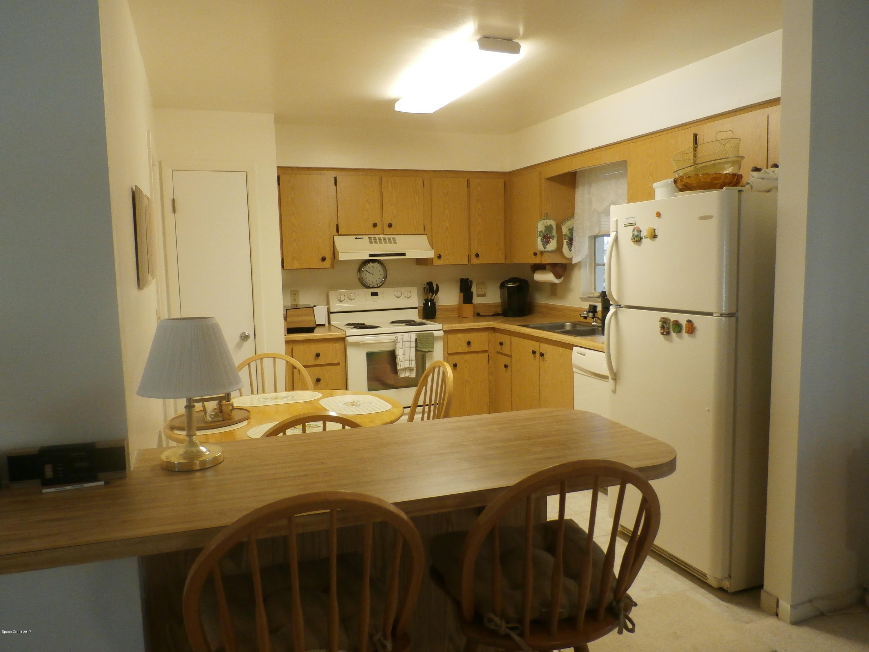 538 Trend Road West Melbourne, FL 32904 - Photo 6 of 16 a kitchen with stainless steel appliances a dining table chairs and refrigerator