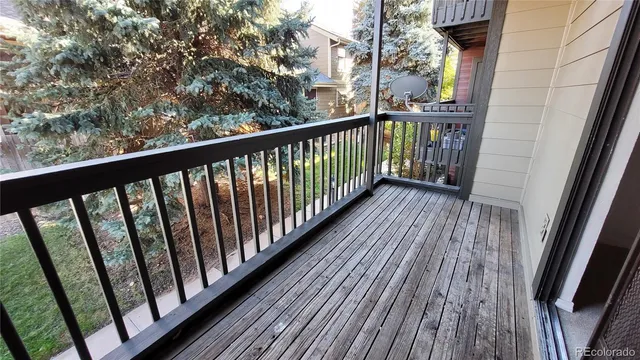 a view of a balcony with wooden floor