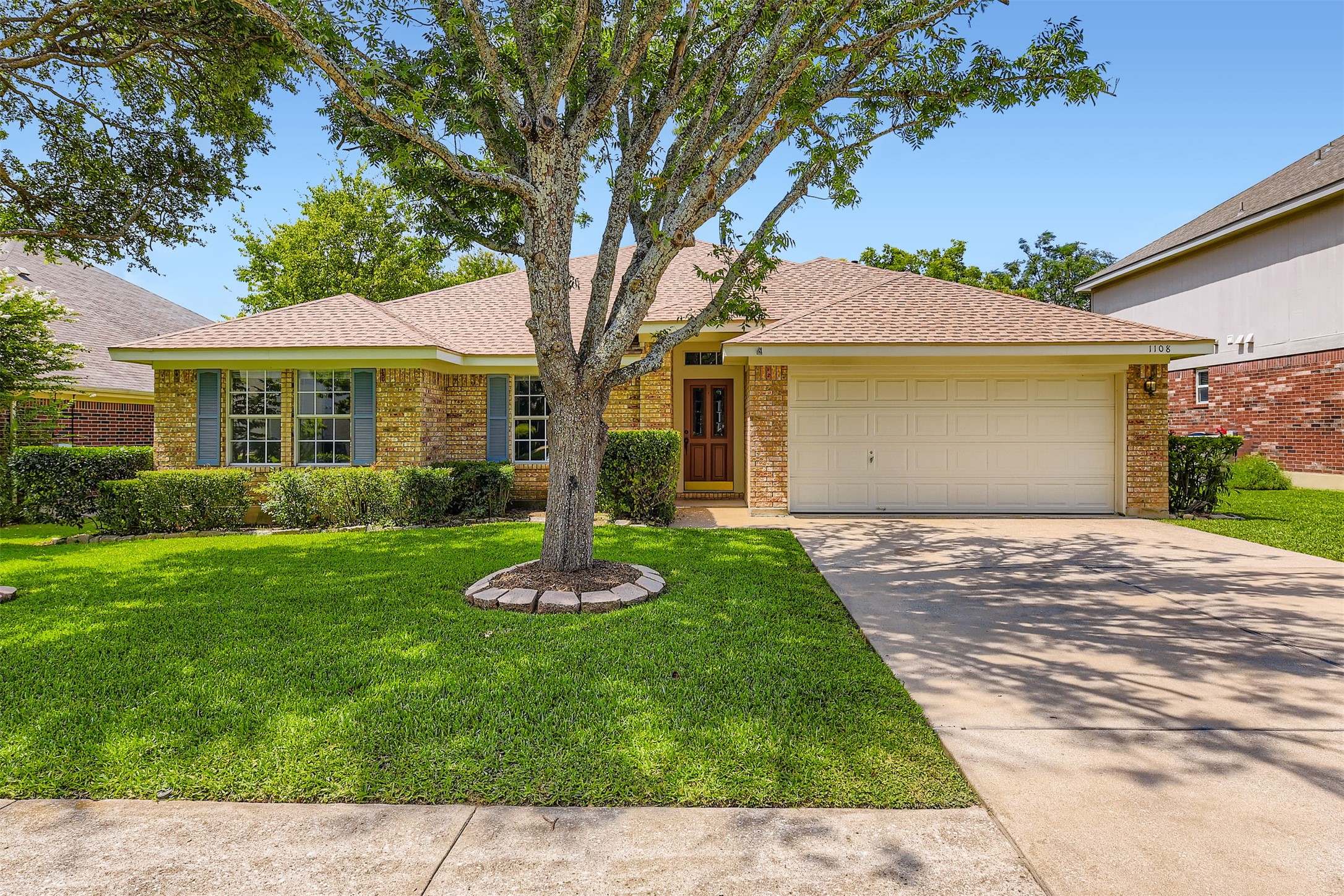 1108 Red Ranch Circle Cedar Park, TX 78613 - Photo 1 of 1 Ranch-style home with concrete driveway, a front lawn, a garage, and brick siding