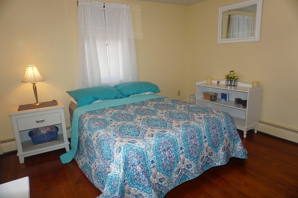 28 Lennon Street Gardner, MA 01440 - Photo 16 of 30 a bedroom with a bed and a lamp on table