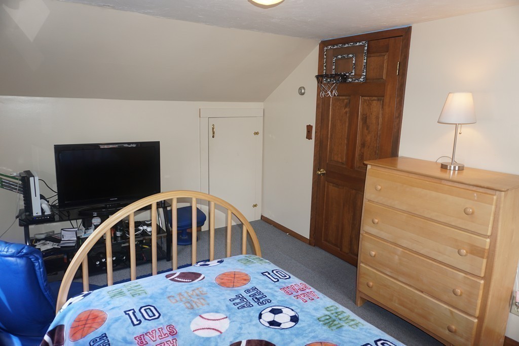 28 Lennon Street Gardner, MA 01440 - Photo 19 of 30 a bedroom with a bed and a flat tv screen on the dresser