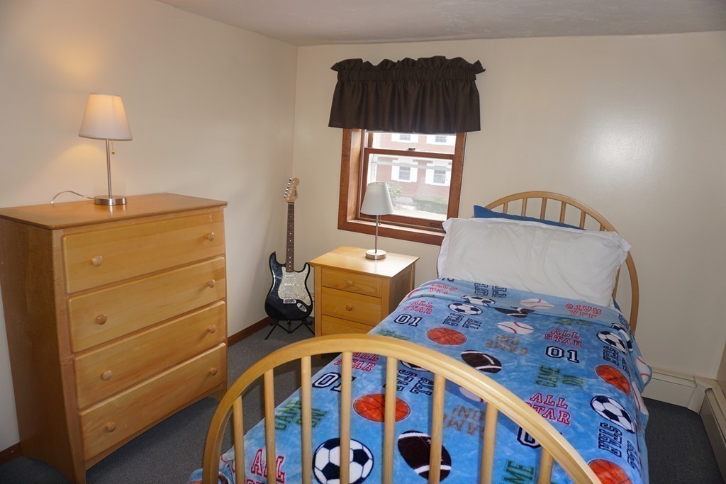 28 Lennon Street Gardner, MA 01440 - Photo 20 of 30 a bedroom with a bed and a lamp on the dresser