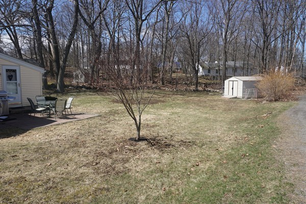 28 Lennon Street Gardner, MA 01440 - Photo 28 of 30 a backyard of a house with a trees