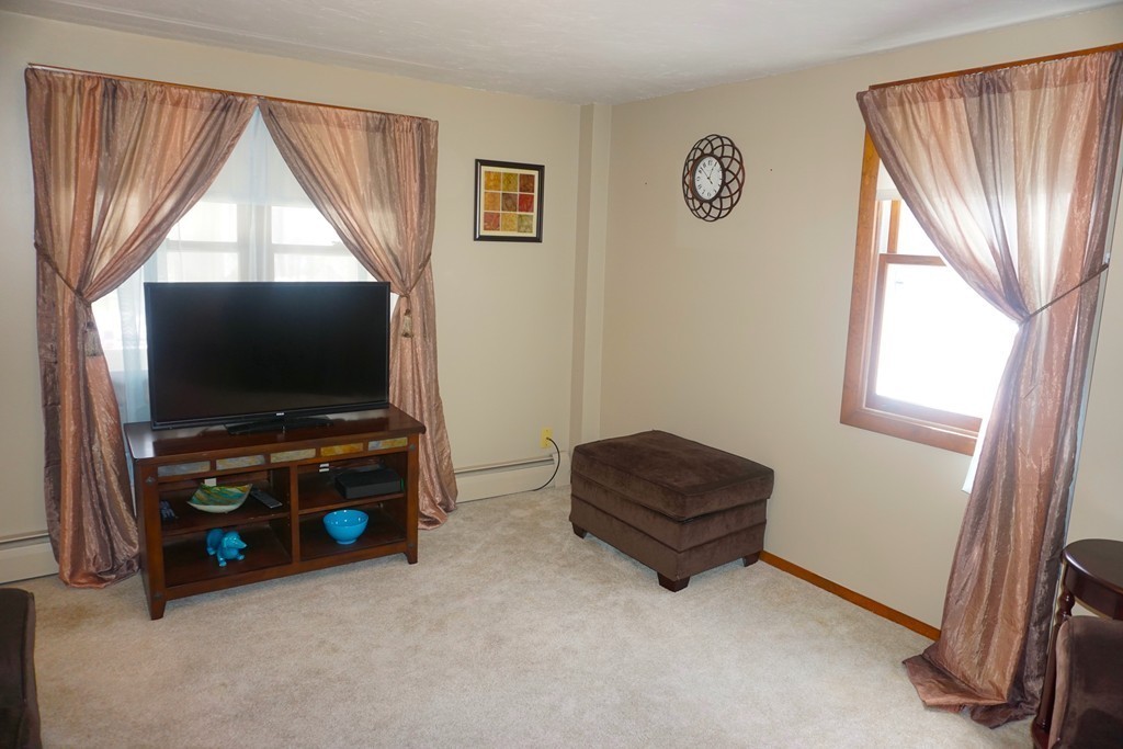 28 Lennon Street Gardner, MA 01440 - Photo 7 of 30 a living room with furniture and a flat screen tv