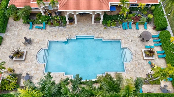 an aerial view of a house with garden space and a patio