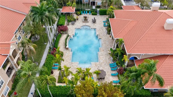an aerial view of a house with a yard and garden