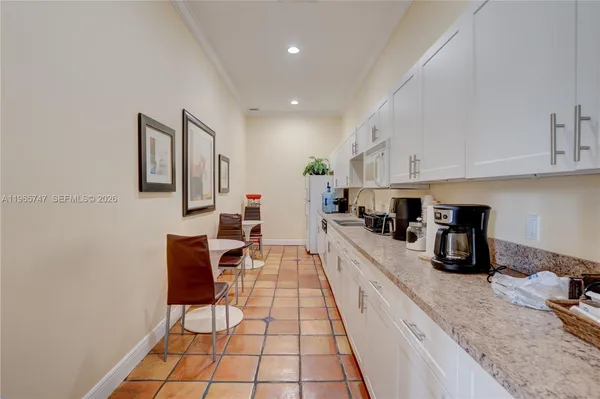 a kitchen with stainless steel appliances granite countertop a sink counter top space and cabinets