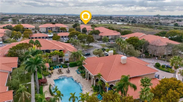 an aerial view of a house with swimming pool and outdoor space