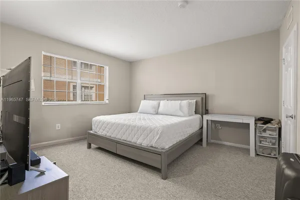 a bedroom with a bed and a desk