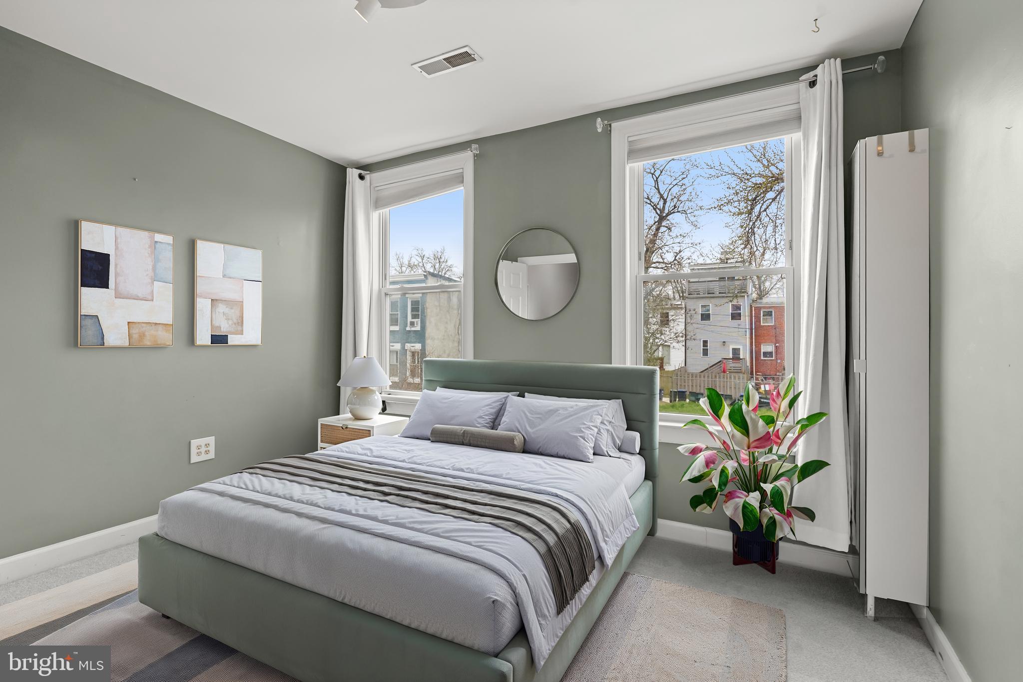 1648 Kramer Street Northeast Washington, DC 20002 - Photo 14 of 30 a bedroom with a bed and a potted plant