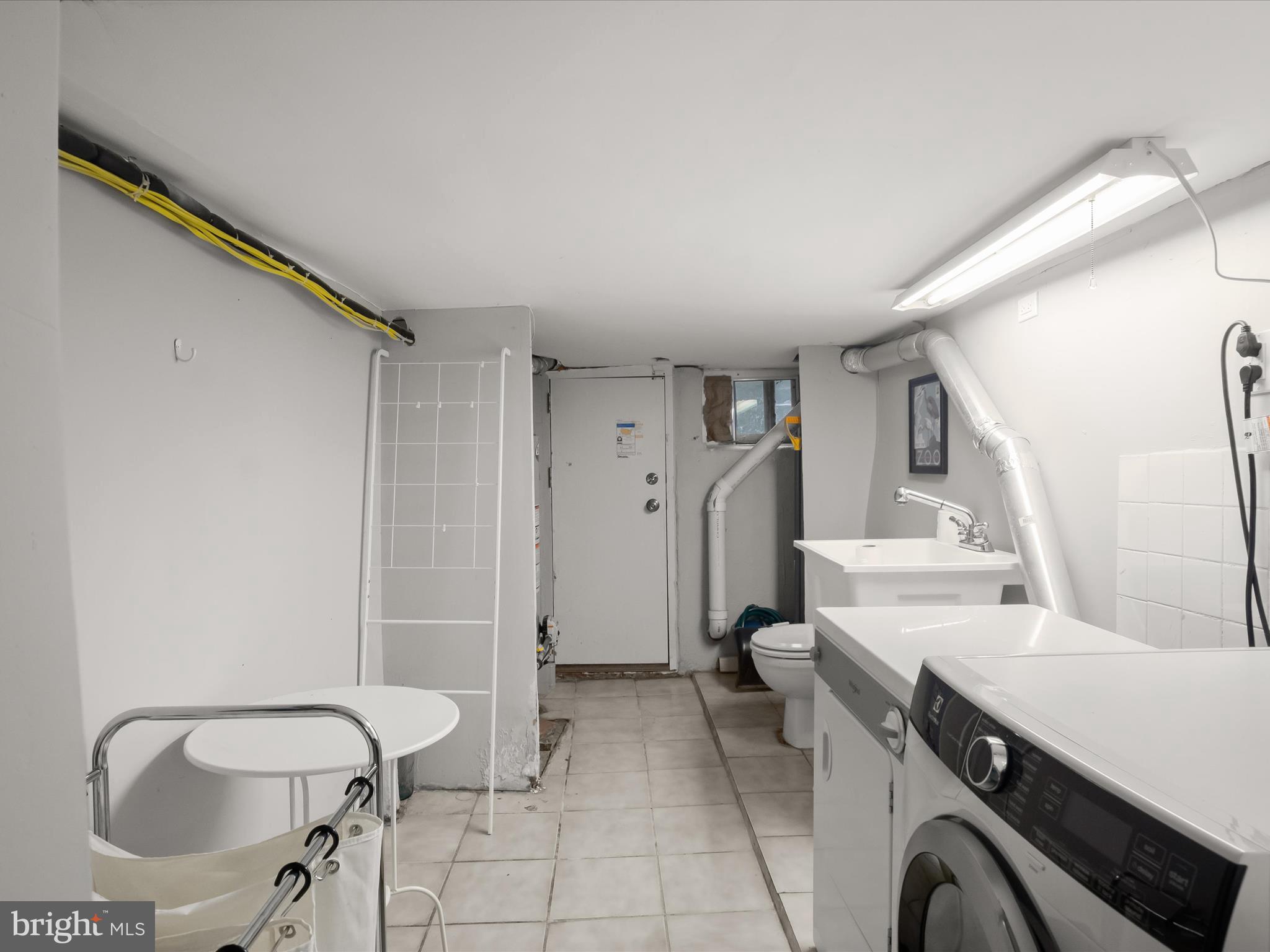 1648 Kramer Street Northeast Washington, DC 20002 - Photo 20 of 30 a spacious bathroom with a sink a toilet and a mirror