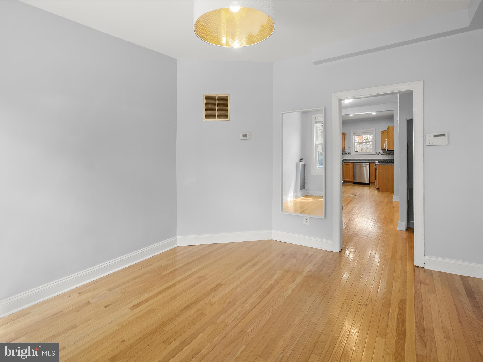 1648 Kramer Street Northeast Washington, DC 20002 - Photo 4 of 30 a view of a big room with wooden floor and windows