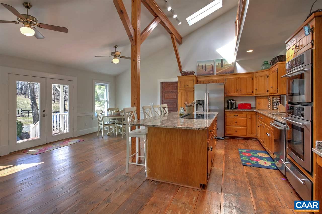 481 Beautiful Run Road Rochelle, VA 22738 - Photo 14 of 45 a kitchen with stainless steel appliances granite countertop a refrigerator a sink dishwasher a stove and a dining table with wooden floor
