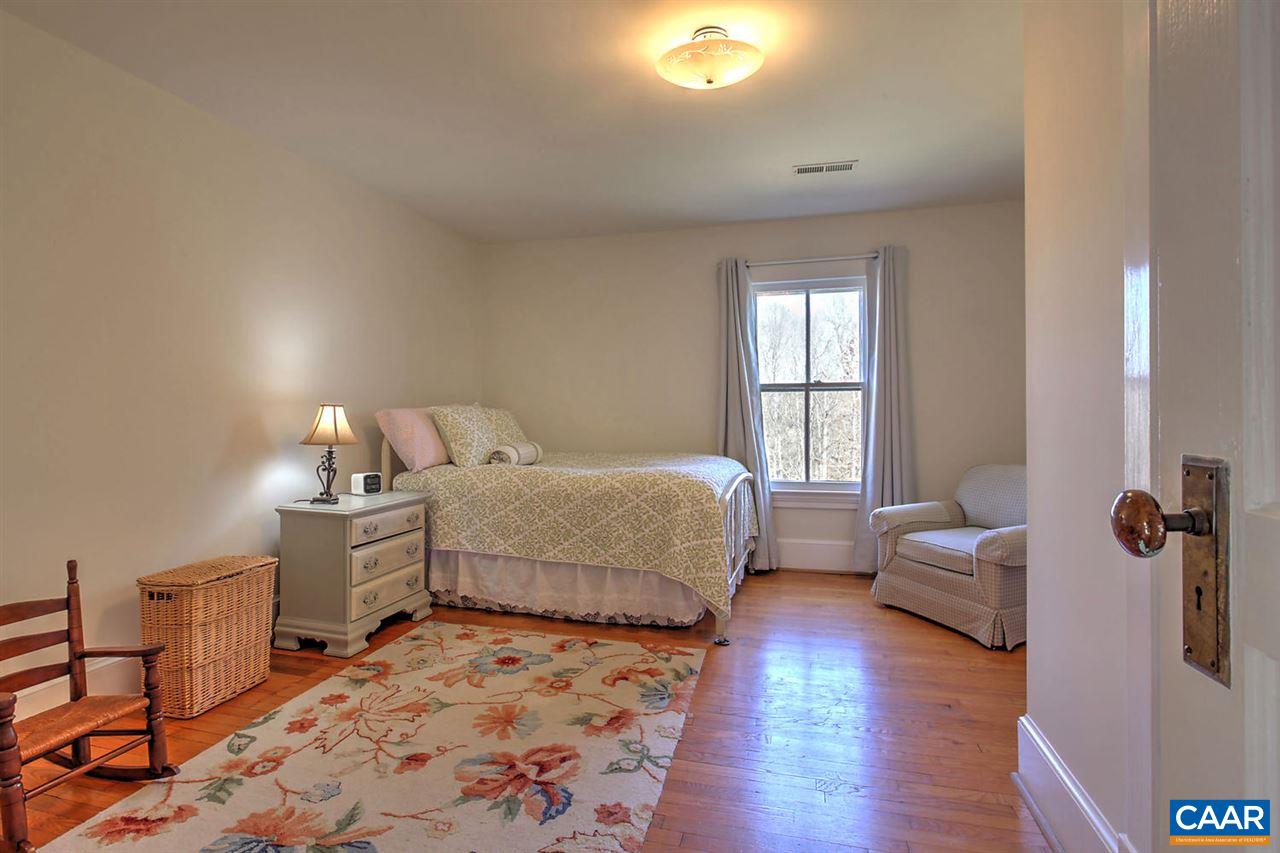 481 Beautiful Run Road Rochelle, VA 22738 - Photo 27 of 45 a bedroom with a bed and wooden floor