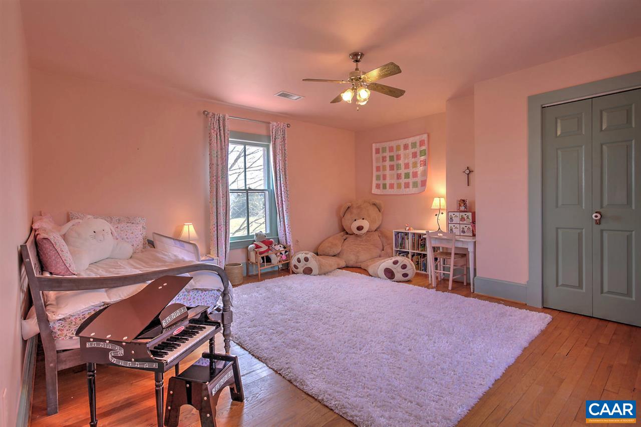 481 Beautiful Run Road Rochelle, VA 22738 - Photo 28 of 45 a bedroom with a bed and a chandelier