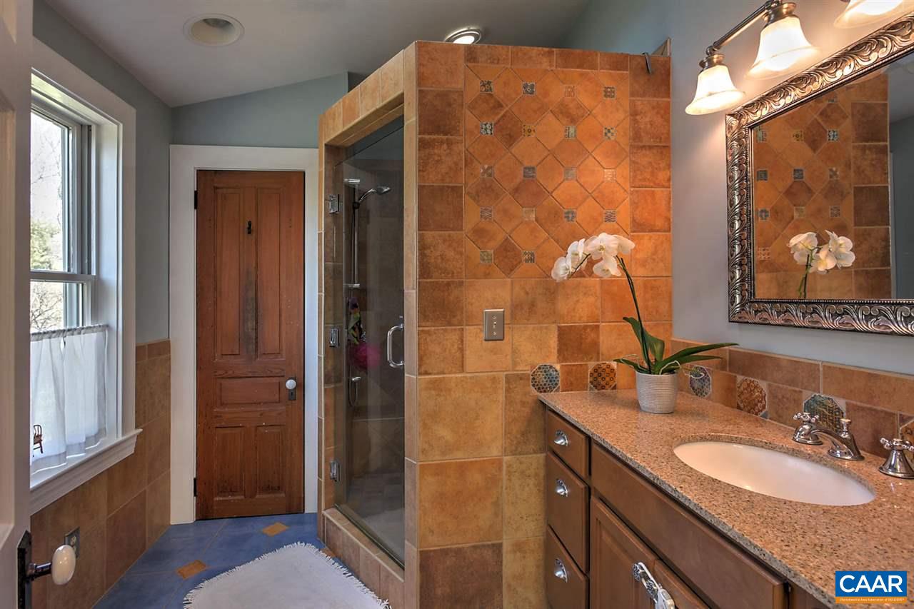 481 Beautiful Run Road Rochelle, VA 22738 - Photo 30 of 45 a bathroom with a granite countertop sink a mirror and shower