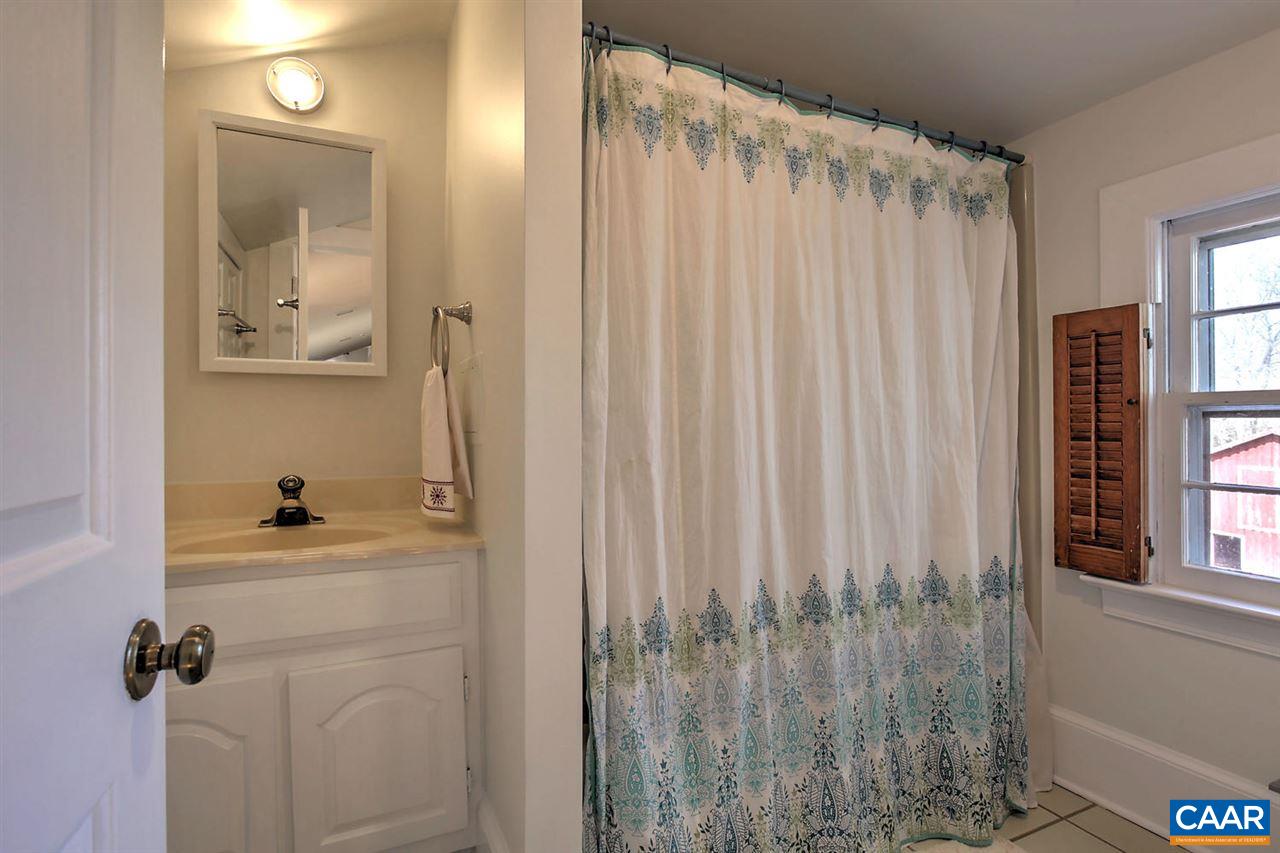 481 Beautiful Run Road Rochelle, VA 22738 - Photo 31 of 45 a bathroom with a shower curtain and a window