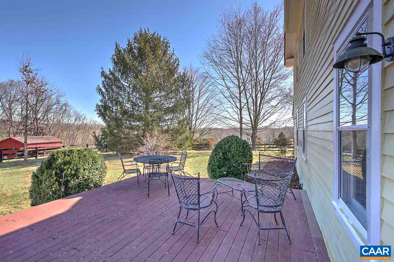 481 Beautiful Run Road Rochelle, VA 22738 - Photo 33 of 45 a patio with table and chairs and potted plants with wooden floor and wall