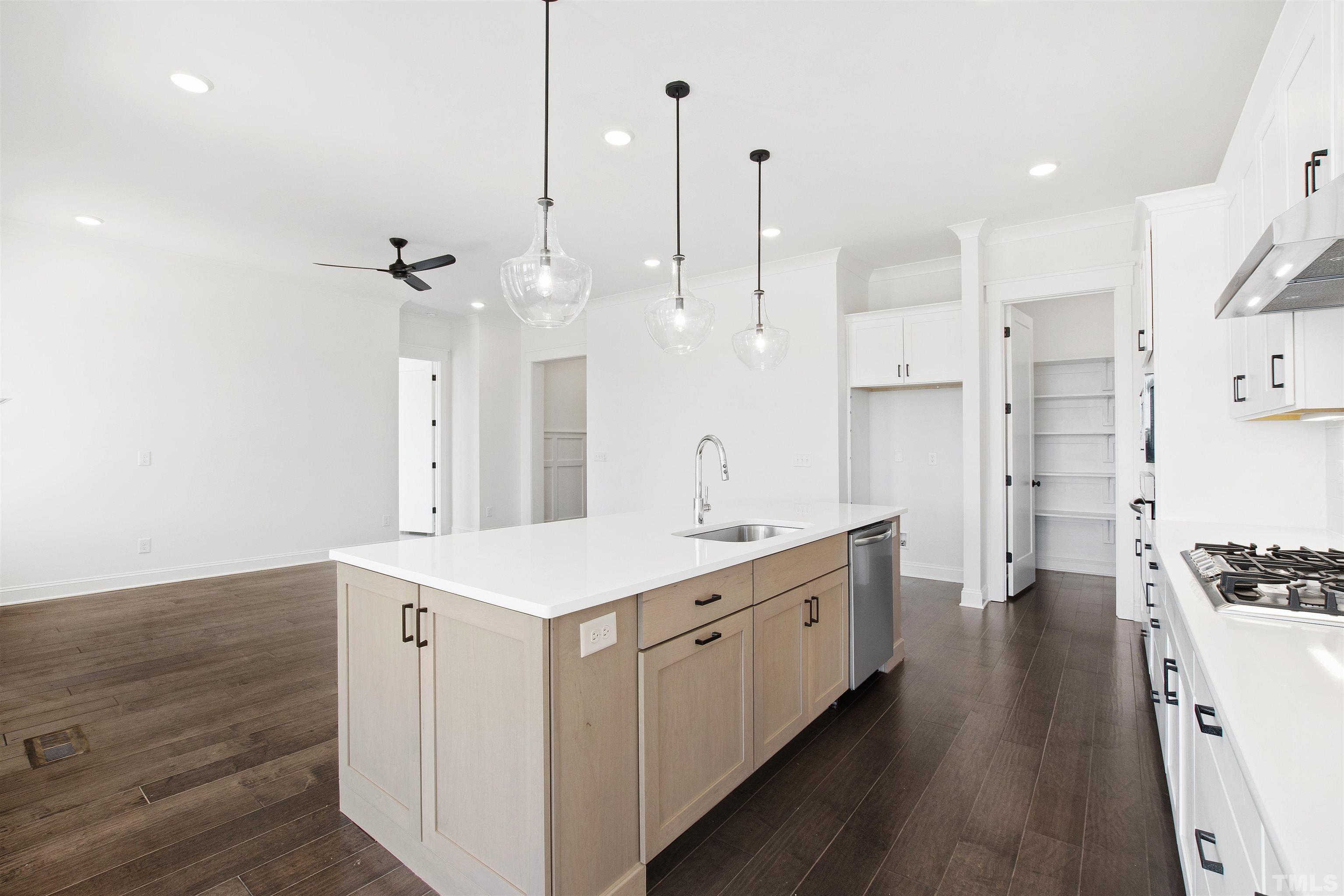 7528 Pinecrest Road Raleigh, NC 27613 - Photo 11 of 45 a kitchen with stainless steel appliances sink stove and wooden floor