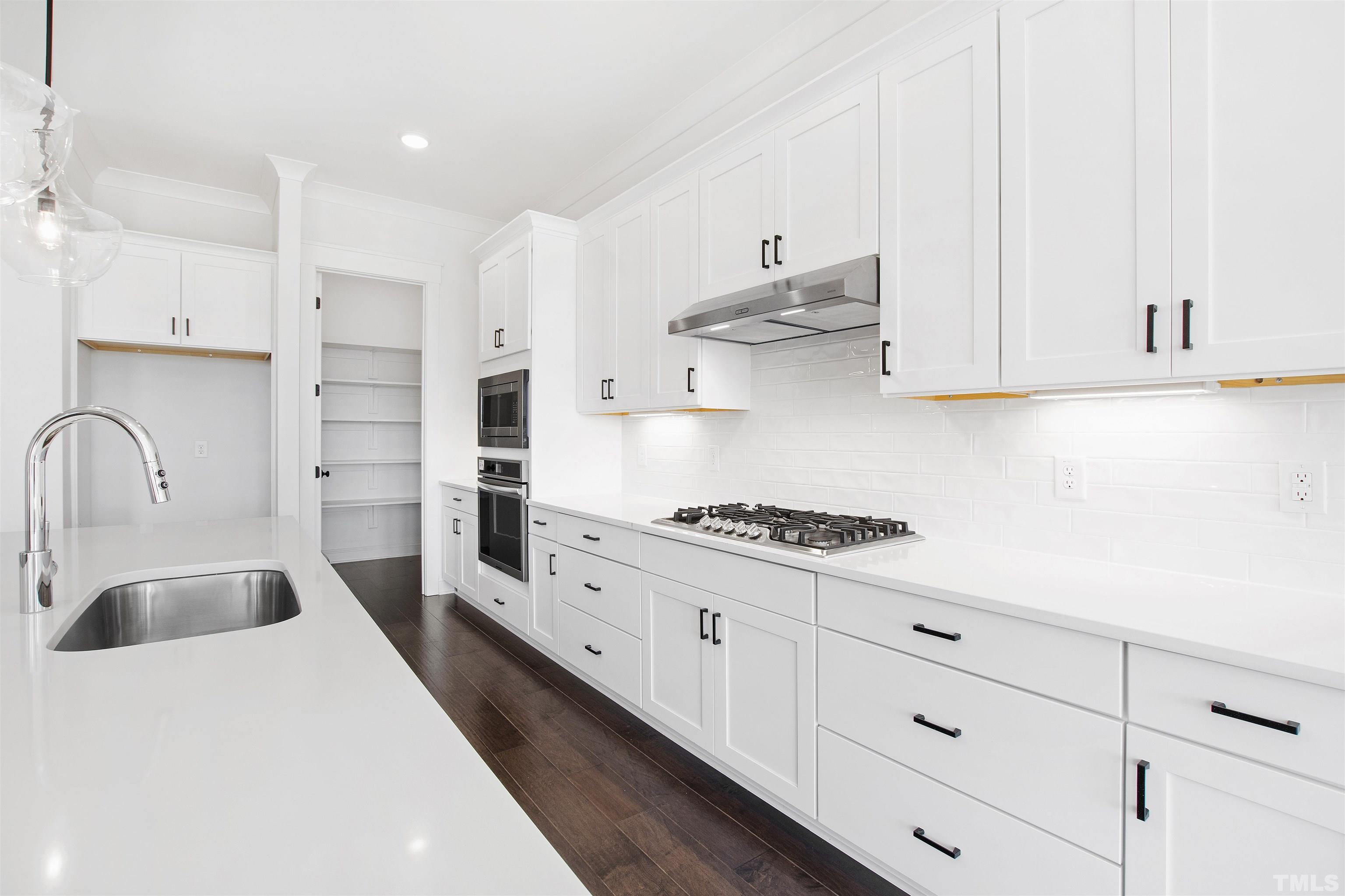 7528 Pinecrest Road Raleigh, NC 27613 - Photo 14 of 45 a kitchen with granite countertop a sink a stove and cabinets