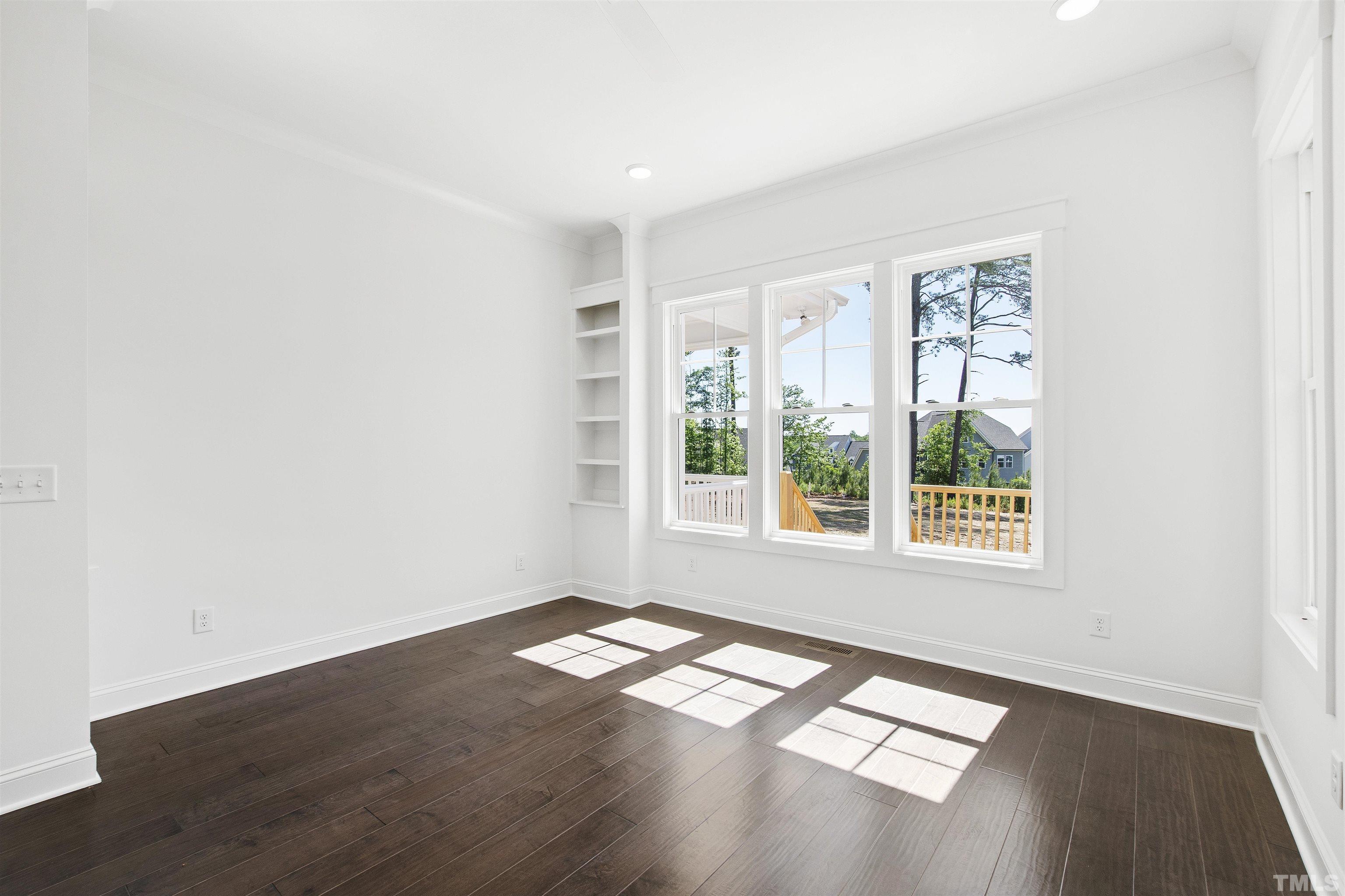 7528 Pinecrest Road Raleigh, NC 27613 - Photo 18 of 45 a view of empty room with wooden floor and fan