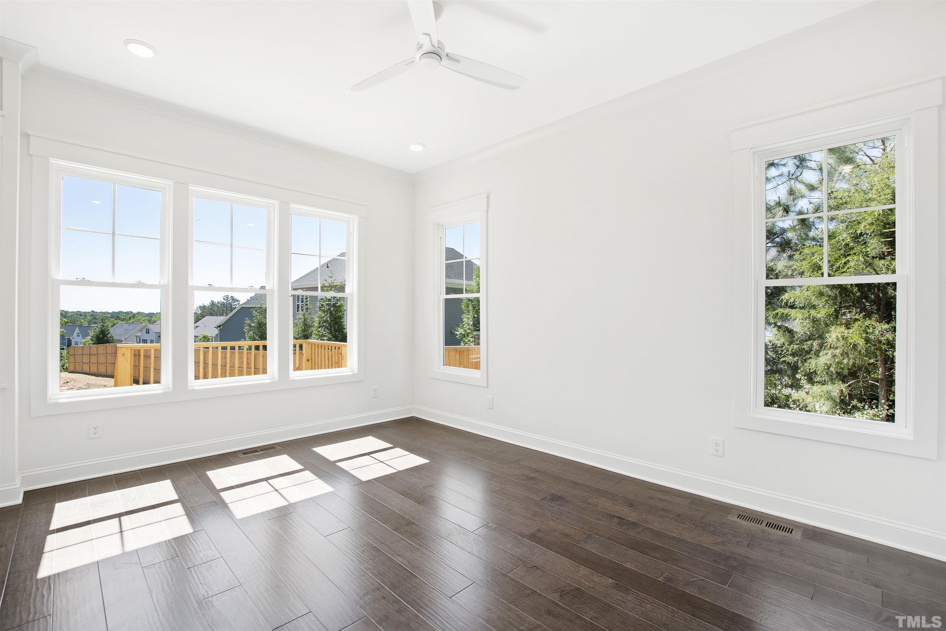 7528 Pinecrest Road Raleigh, NC 27613 - Photo 19 of 45 an empty room with wooden floor and windows