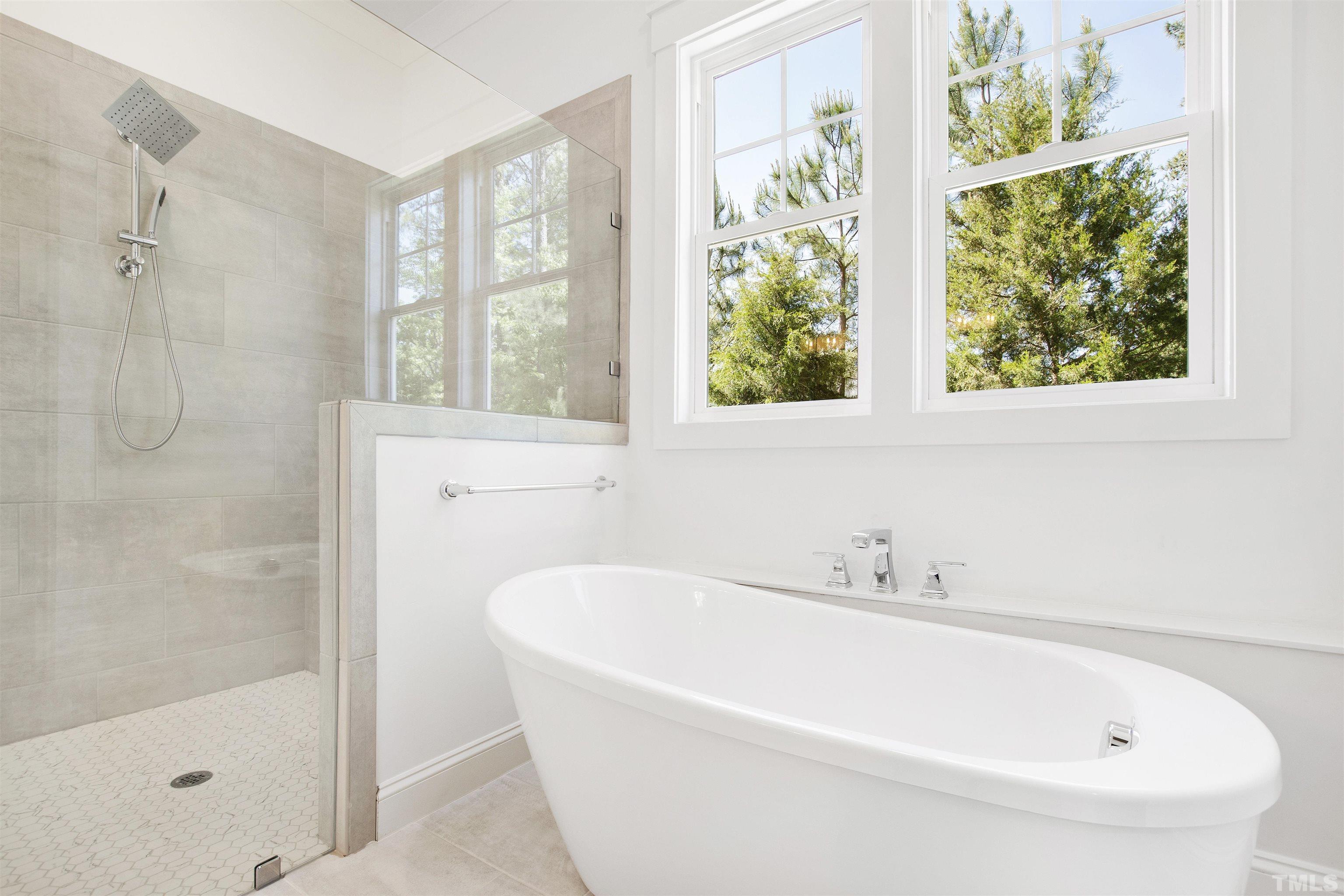 7528 Pinecrest Road Raleigh, NC 27613 - Photo 23 of 45 a white bath tub sitting next to a shower