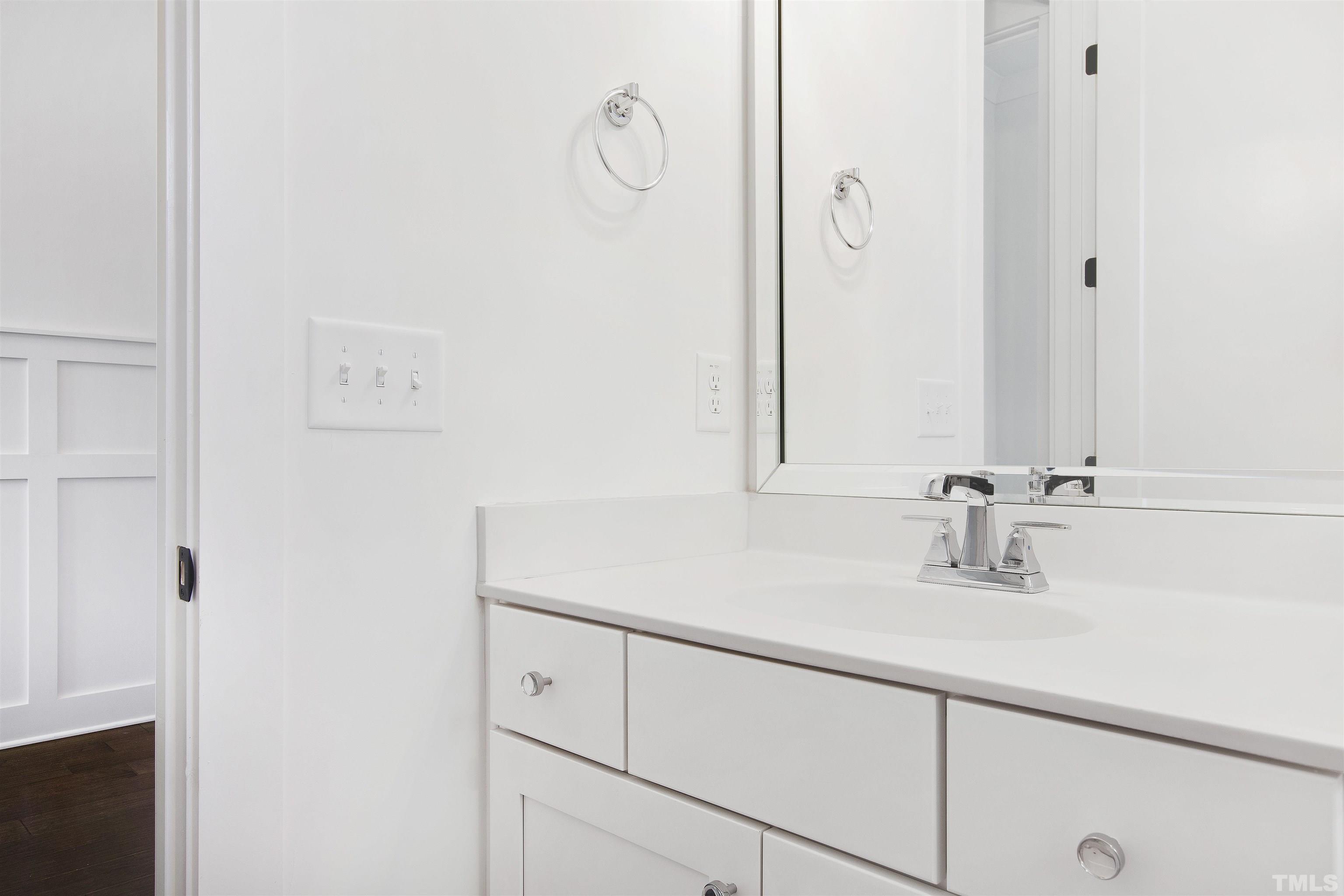 7528 Pinecrest Road Raleigh, NC 27613 - Photo 26 of 45 a bathroom with a sink and a mirror