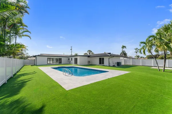 a view of a house with pool and a big yard