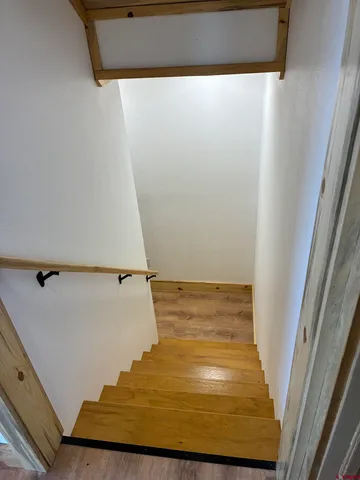 a bedroom with a bed and a ceiling fan
