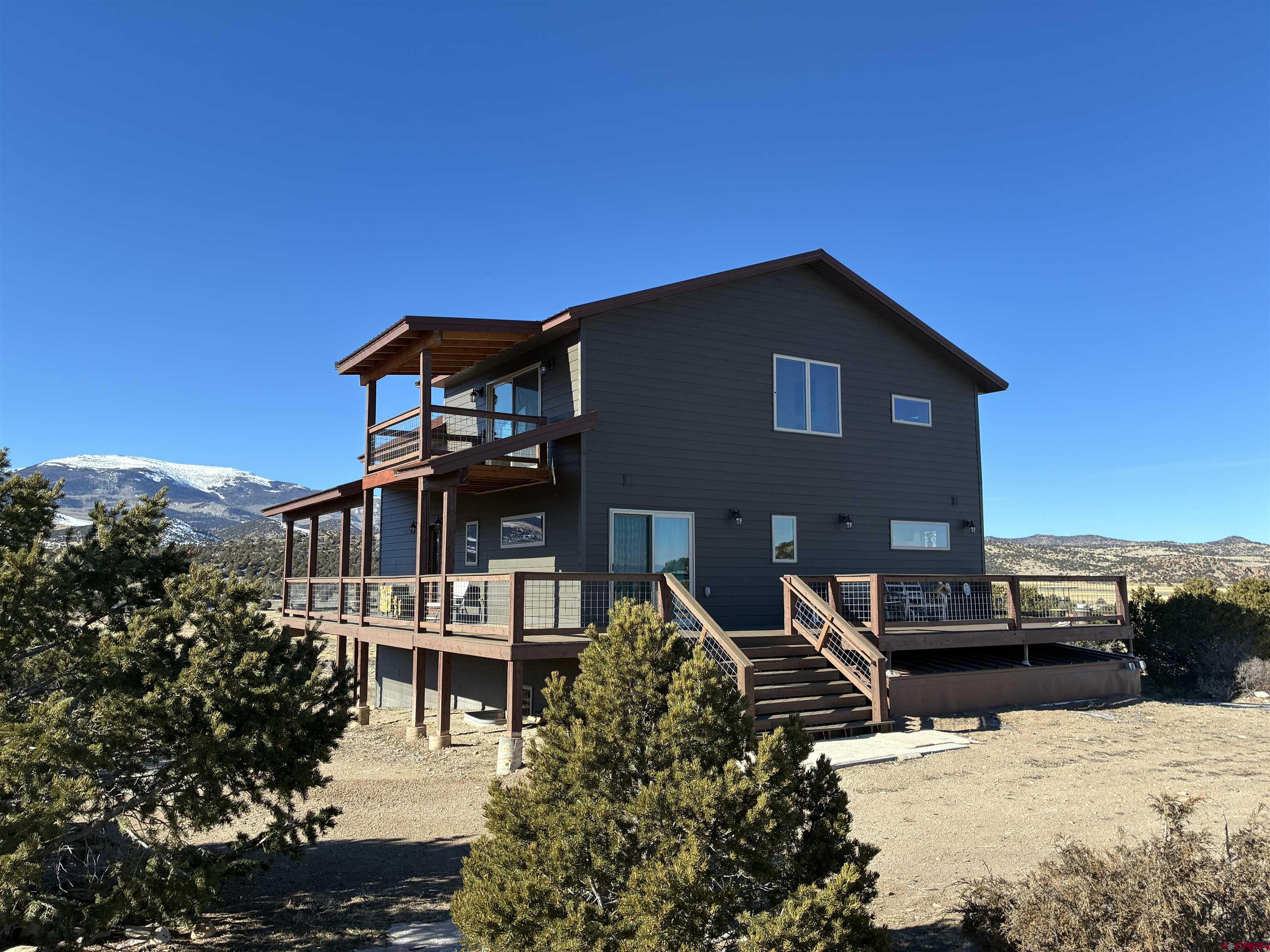 180 Boulder Lake Road Monte Vista, CO 81144 - Photo 2 of 35 a front view of a house with a yard