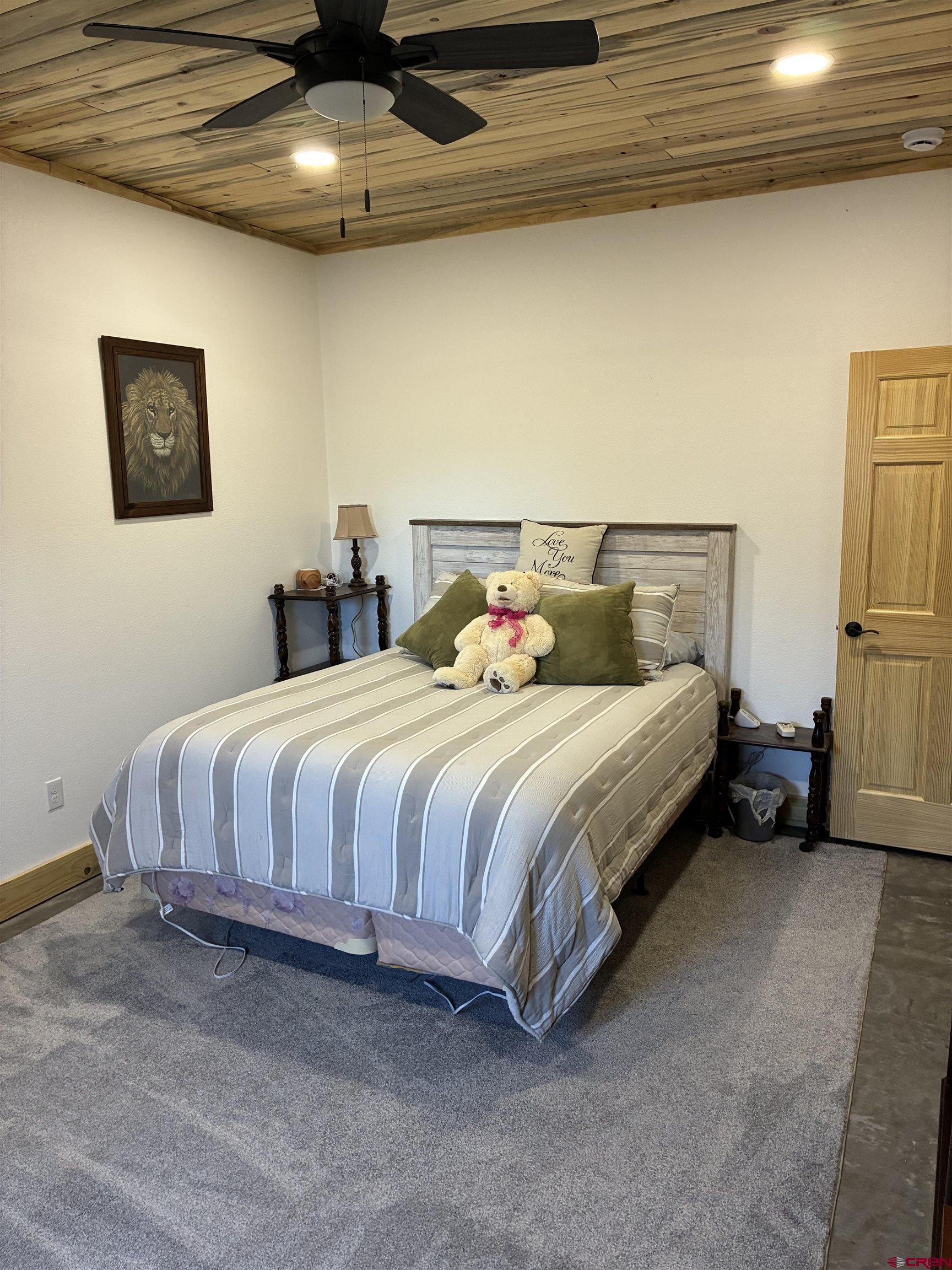 180 Boulder Lake Road Monte Vista, CO 81144 - Photo 21 of 35 a bedroom with a bed and a ceiling fan