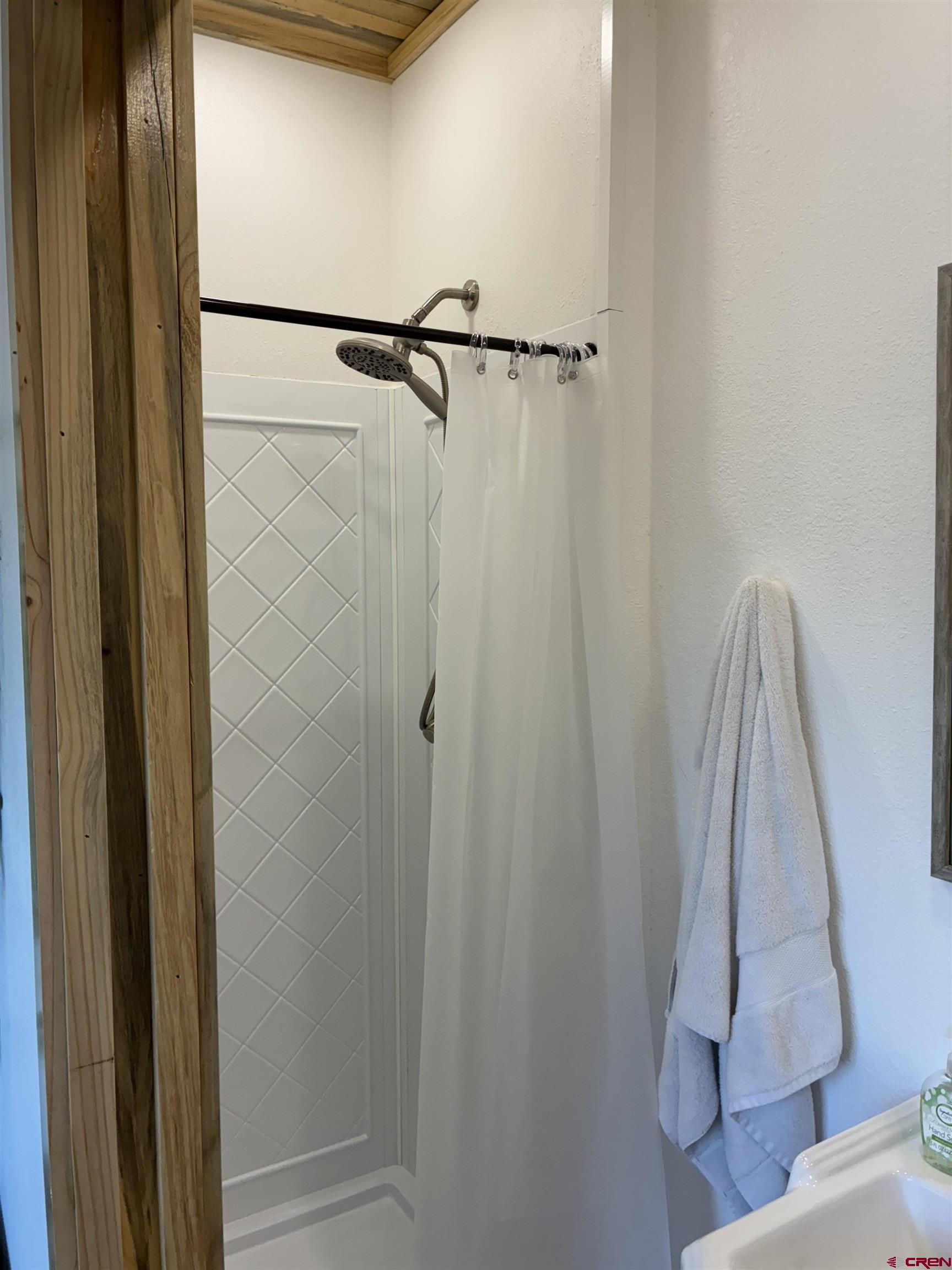 180 Boulder Lake Road Monte Vista, CO 81144 - Photo 26 of 35 a bathroom with a shower and vanity