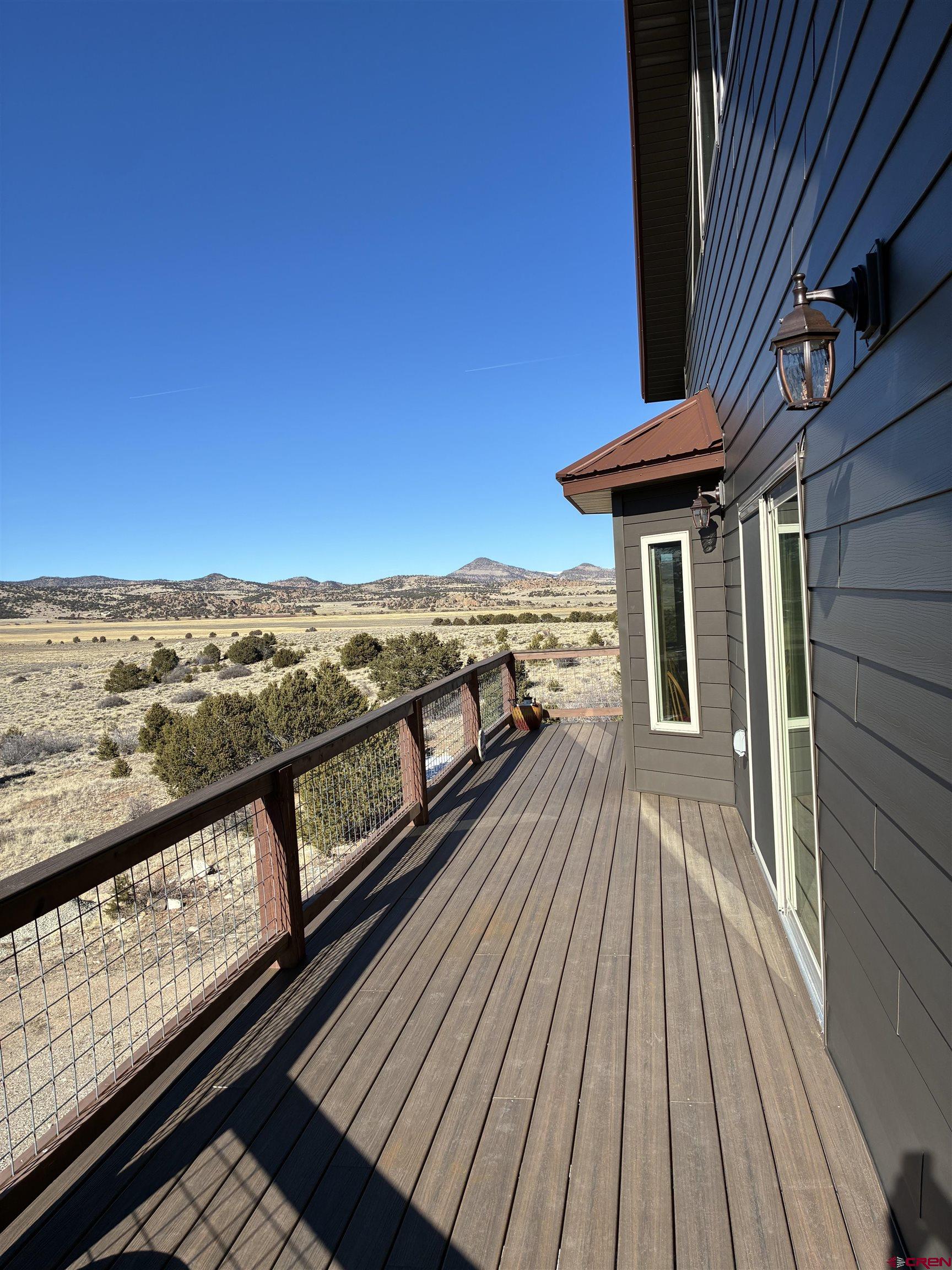 180 Boulder Lake Road Monte Vista, CO 81144 - Photo 29 of 35 a view of a balcony with wooden floor and outdoor seating