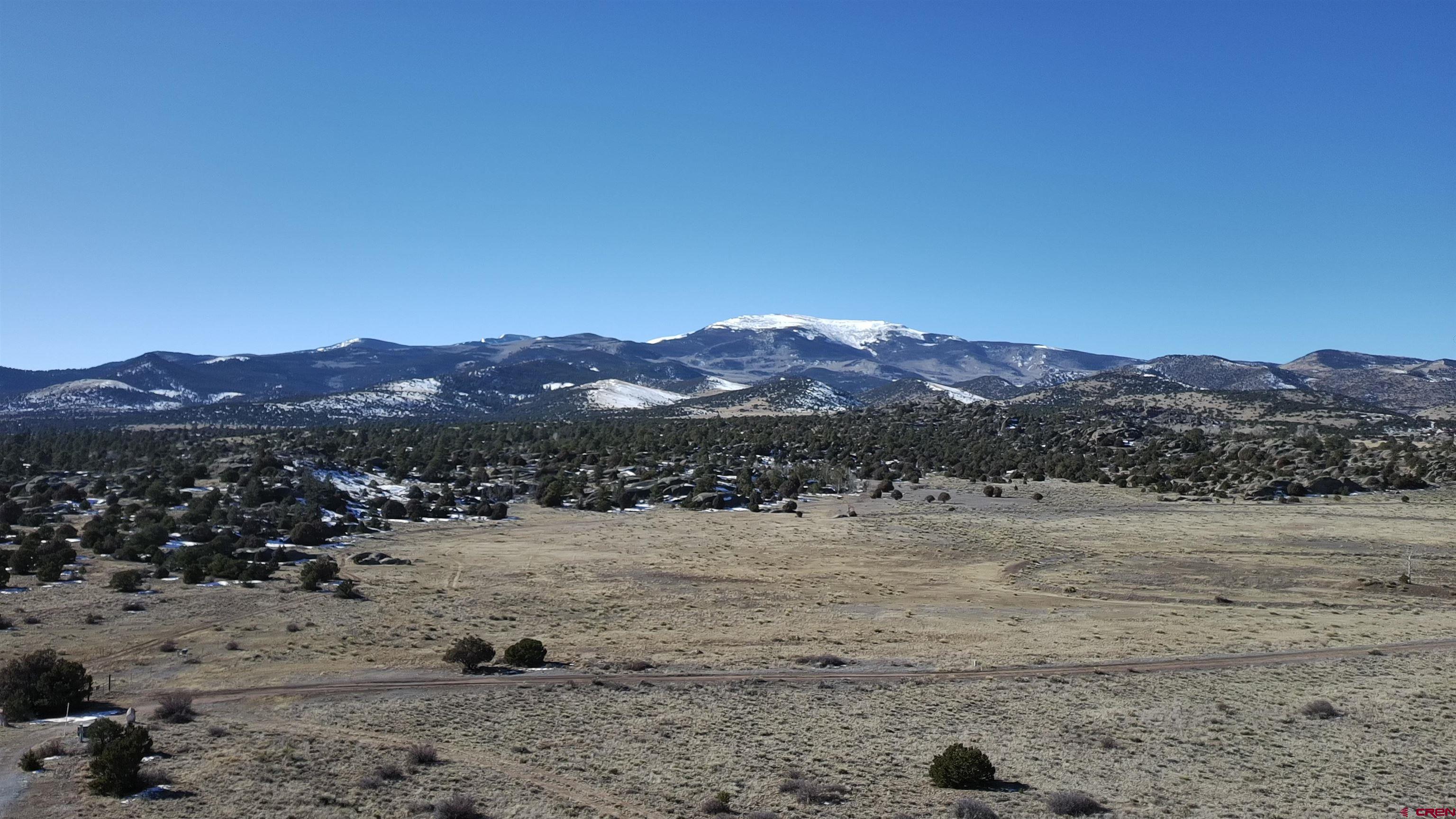 180 Boulder Lake Road Monte Vista, CO 81144 - Photo 35 of 35 a view of a dry field with mountains in the background