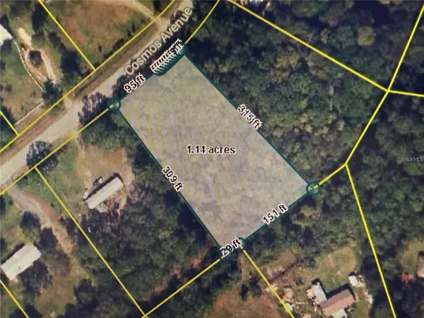 an aerial view of a houses with a yard