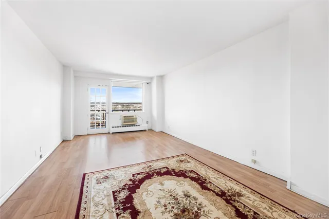 a view of a room with a bed and a window