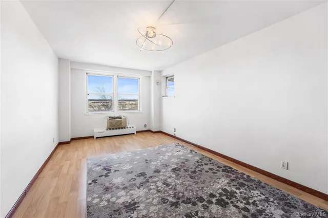 a view of a room with wooden floor and window
