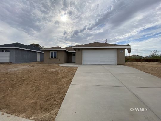 1405 Porter Street Ridgecrest, CA 93555 - Photo 1 of 23 a house with a bench in front of it