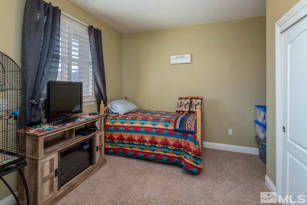 621 Steeplechase Court Reno, NV 89521 - Photo 11 of 18 a bedroom with furniture and flat screen tv