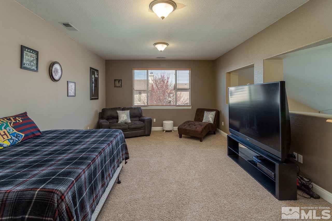 621 Steeplechase Court Reno, NV 89521 - Photo 13 of 18 a hotel room with two bed and a flat screen tv