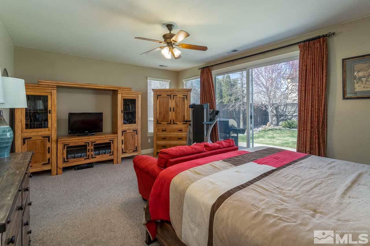 621 Steeplechase Court Reno, NV 89521 - Photo 10 of 18 a bedroom with a bed and a flat screen tv