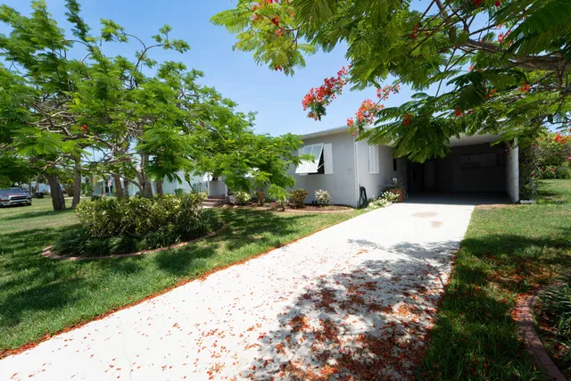 a view of a patio with couches chairs potted plants and garden